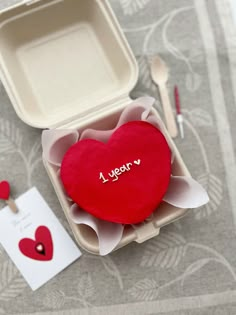 a heart shaped cake in a box with the word i love you written on it