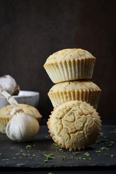 three muffins stacked on top of each other next to garlic