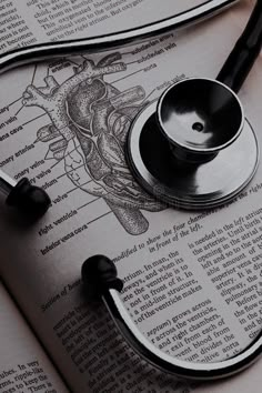 a stethoscope laying on top of an open book