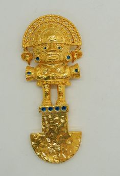 a gold brooch with an image of a man holding a shield and two blue eyes