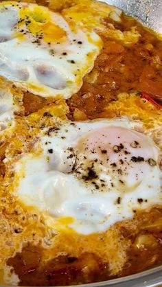 an omelet with three fried eggs on top in a pan, ready to be eaten