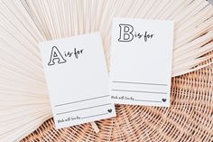 two personalized notepads sitting next to each other on a wicker basket