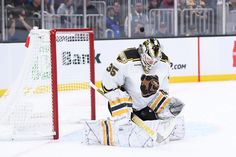 a hockey goalie sitting in front of the net