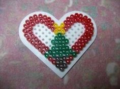 a heart shaped beaded decoration with beads on it's side and the colors of the flag