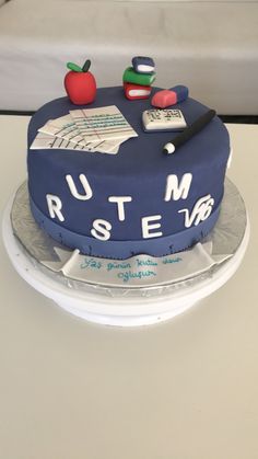 a cake that is on top of a white tablecloth with writing and an apple