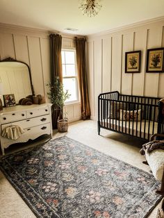 a baby's room with a crib, dresser and bed in it that has a rug on the floor