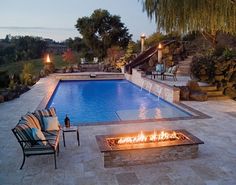 a fire pit sitting next to a swimming pool