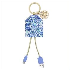 a blue and white keychain shaped like a house