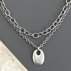 🟣HANDMADE in California, QUALITY materials 🟣FOR THE CHUNKIER VERSION OF THIS SET, IN OUR SHOP'S SEARCH BOX ENTER: chunky oval 🟢CHAIN:  -stainless steel (long-lasting, durable, raw and silver plated) -TWO SEPARATE NECKLACES -14 inch and 16 inch, OR -16 inch and 18 inch (average neck size), OR -18 inch and 20 inch  -see Sizing Chart photo -Need a longer/looser fit? See NECKLACE EXTENDERS in Main Menu 🟢PENDANT:  *antiqued silver plated base metal -tarnish resistant coating 🟦CARE INSTRUCTIONS: To maintain the color and shine of our fashion jewelry: avoid contact with beauty/body products and water/perspiration; clean with a jewelry polishing cloth; and use airtight storage (1123)(8X6o-link,3mmcable)(MCact3/2,50,25chm,25/PR23/PC34+5) Thick Silver Necklace, Necklaces Layered, Chunky Silver Necklace, Sophisticated Casual, Airtight Storage, Necklace Extender, Main Menu, Beauty Body, Metal Pendant