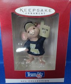 a mouse figurine with a baseball jersey on it's head in a box