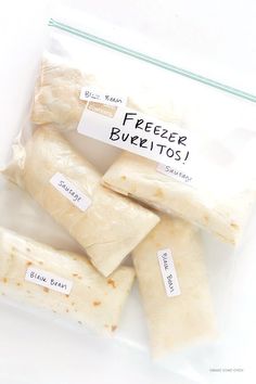 there are five burritos wrapped in plastic