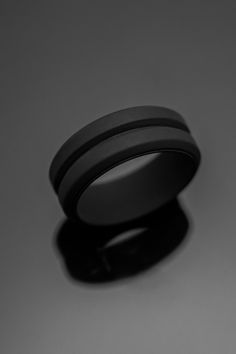 a black ring sitting on top of a table