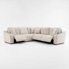 a large sectional sofa with pillows on the bottom and back ends, sitting in front of a white background