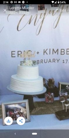 a table topped with a white cake covered in frosting and surrounded by pictures on it