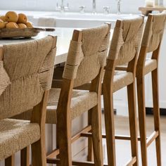 there are many chairs at the counter in this kitchen