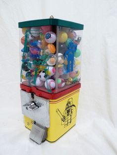 an old fashioned candy dispenser with lots of candies in it