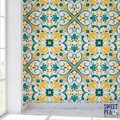 an ornate wallpaper with blue, yellow and green designs on the outside of it