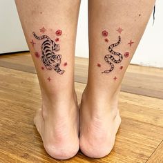 two tattoos on the legs of a woman with cats and stars around her ankles,