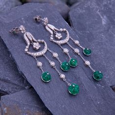 These dazzling chandelier earrings are each accented with three (3) carved emerald flower dangles and forty-four (44) round brilliant cut diamonds that are prong and bezel set. The earrings measure 75.1mm long by 21.0mm wide and they are finished with friction backs for pierced ears. Luxury Green Dangle Chandelier Earrings, Green Diamond Chandelier Drop Earrings, Elegant Green Earrings With Rose Cut Diamonds, Carved Emerald, Diamond Chandelier Earrings, Diamond Chandelier, Aquamarine Rings, March Birth Stone, Emerald Diamond