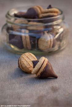 a jar filled with cookies and chocolates on top of a table