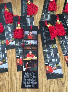 some red tassels are laying on top of a wooden table next to pictures