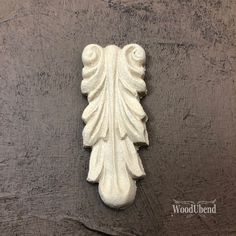 a white carved object on a wooden surface