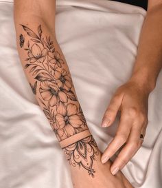 a woman's arm with flowers on it