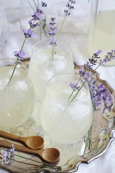 lavender water in glasses and wooden spoons on a tray