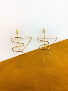 Minimalist Handmade Metal Linear Earrings, Modern Wire Wrapped Earrings, Modern Wire Wrapped Drop Earrings, Artsy Gold Wire Wrapped Earrings, Minimalist Gold Wire Wrapped Earrings, Minimalist Wire Wrapped Gold Earrings, Modern Brass Wrap Earrings As Gift, Modern Brass Wrap Earrings For Gift, Diy Jewlery