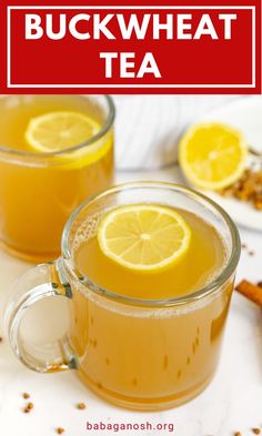 two mugs filled with tea and topped with lemon slices