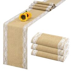 the table runner is decorated with sunflowers and lace