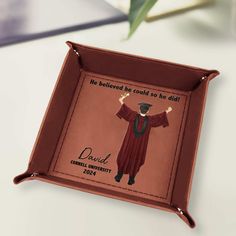 a brown tray with a graduation photo on it