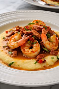 shrimp and grits on top of mashed potatoes