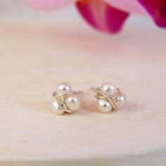 These dainty freshwater pearl stud earrings, have been hand wired with Sterling Silver, into a unique design, that are a great everyday accessory and would make a perfect special gift.  Each item in our collection, is designed and handmade by Fran in our sunny Suffolk studio. - Pearls are thought to be a symbol of love, wisdom and luck.  - Size - appx. 6mm wide - Natural Freshwater Pearls, 925 Sterling Silver Posts and Butterfly Backs. - Pearls are the birthstone of June. Your pearl stud earring Dainty Wire Wrapped Earrings For Wedding, Dainty Wire Wrapped Pearl Earrings For Wedding, Dainty Wire Wrapped Pearl Earrings As Gift, Dainty Wire Wrapped Pearl Earrings For Gift, Dainty Wire Wrapped Wedding Earrings, Delicate Wire Wrapped Pearl Earrings For Wedding, Delicate Pearl Earrings Wire Wrapped, Delicate Wire Wrapped Pearl Earrings, Pearl Wire Wrapped Earrings For Anniversary