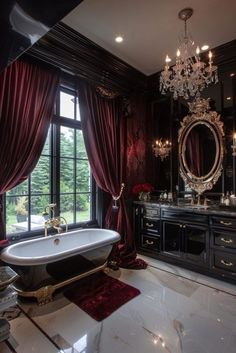 a fancy bathroom with a claw foot tub and chandelier