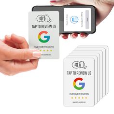 someone is holding up five business cards with the text tap to review us on them