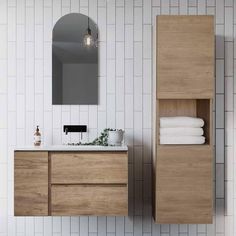 a bathroom with a sink, mirror and towel rack