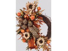 a wreath with leopard print ribbon and flowers