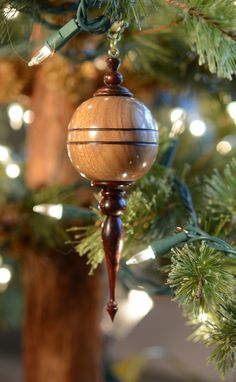 a wooden ornament hanging from a tree