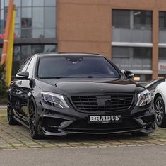 two cars parked next to each other in front of a building