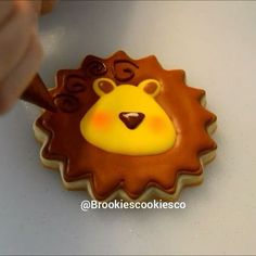 a cookie shaped like a lion is being decorated