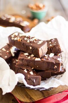 chocolate bars stacked on top of each other with nuts in the background and text overlay that reads toasted almond & chocolate protein bars