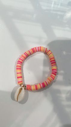 a bracelet with a seashell charm on it