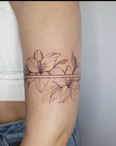 a woman's arm with a flower tattoo on the left side of her body