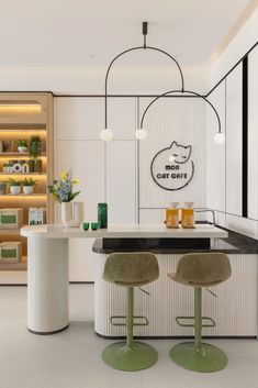 a kitchen with two stools next to a counter