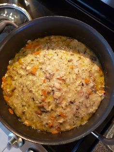 a pan filled with food sitting on top of a stove