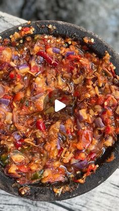 a pan filled with food sitting on top of a wooden table