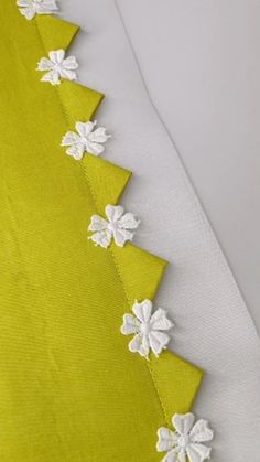 the white flowers are on the green fabric