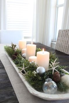 a tray with candles and christmas decorations on it