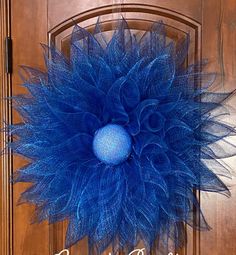 a blue wreath is hanging on the front door